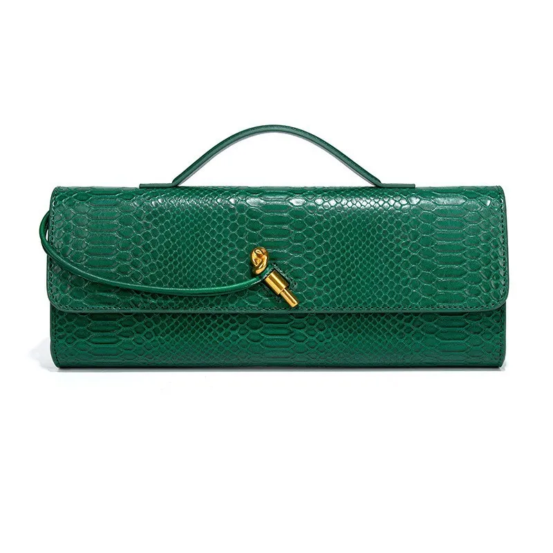 A luxurious green crocodile-embossed leather handbag with a flap closure. The structured rectangular design features a sleek top handle and a wraparound leather strap secured by a gold-tone hardware accent. The elegant and sophisticated style makes it a perfect accessory for formal and evening occasions.