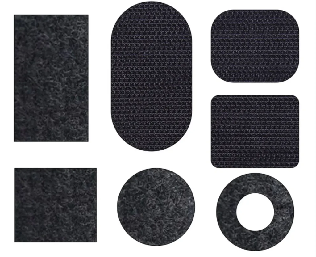 A set of black hook and loop fastener closures in various shapes, including rectangles, squares, circles, and ovals. These adhesive-backed or sew-on fasteners are designed for secure attachment in clothing, bags, shoes, and other accessories. The textured hook side and the soft loop side ensure a strong yet adjustable fastening solution for different applications.